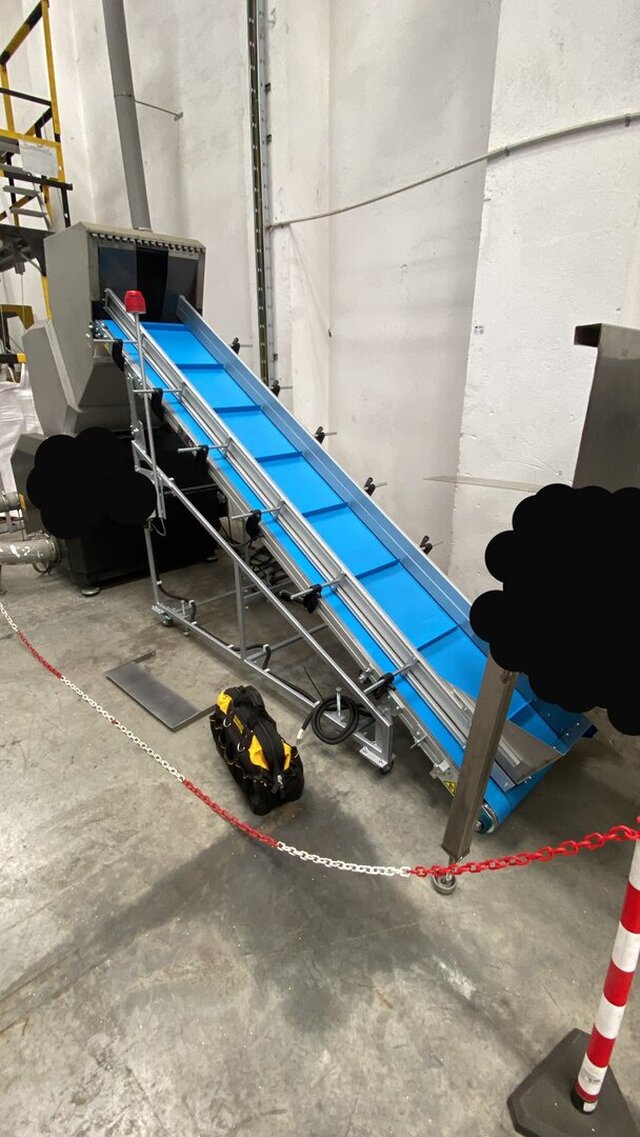 Inclined Conveyor with Adjustable Incline Angle.